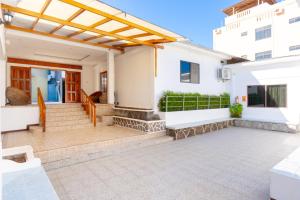 a patio with awning and stairs to a house at Hotel Mar Azul in Puerto Baquerizo Moreno