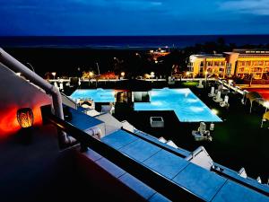a view of a swimming pool at night at Las Mareas Sea View Terrace 3 min to Beach in Morro del Jable +11 photos