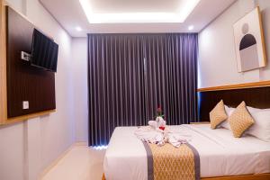 a bedroom with a bed with towels on it at D'House Seminyak in Seminyak