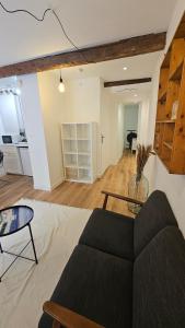 a living room with a couch and a table at Le panier à vos pieds in Marseille