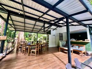 a kitchen and dining room with a large wooden table at Finca Ardilla Jungle Lodge in Cocles