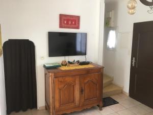 a television on top of a wooden cabinet in a room at Petite marie in Saintes-Maries-de-la-Mer