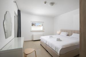 a white bedroom with a white bed and a window at Villa D&J in Vodnjan +42 photos