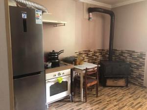a kitchen with a stove and a table in it at Matarta in Mestia