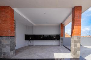 an empty living room with a tv on the wall at D'House Seminyak in Seminyak