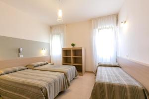 Voodi või voodid majutusasutuse Hotel Colonna toas