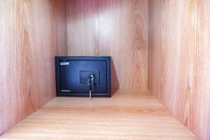 a small television with a key in a room at D'House Seminyak in Seminyak