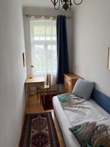 a bedroom with a bed and a table and a window at Ferienwohnungen Dr. Neubert in Krems an der Donau