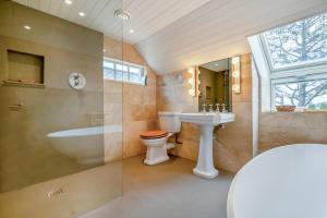 a bathroom with a tub and a sink and a toilet at Little Lanherne Farm Cottage in Saint Mawgan +26 photos