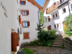 a white building with a staircase leading up to it at Chesa Foulla Rosa - 6 pax in Celerina
