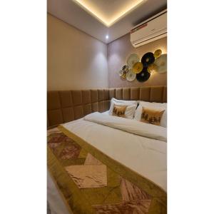 a bedroom with a bed and a wall with fans at Jaltara Stays in Jaipur