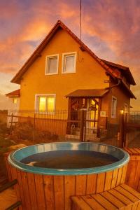 a house with a hot tub in front of a house at Narcise kulcsoshaz in Joseni
