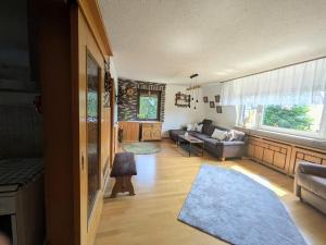 a living room with a couch and a table at Mansardenwohnung Waldblick in Lichtenstein