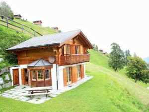 a small wooden house on a hill with a bench at Chalet in Rhone Valley near Ski Lift in Les Collons