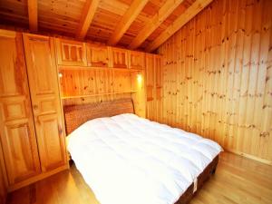 a bedroom with a bed in a wooden room at Chalet in Rhone Valley near Ski Lift in Les Collons