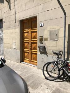 a bike parked in front of a building with a door at Indipendenza 1 in Florence