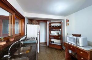 a kitchen with a sink and a microwave at Casarão Boutique Casaboa in Itacaré +11 photos