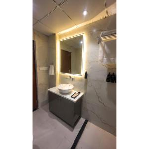 a bathroom with a sink and a mirror at Jaltara Stays in Jaipur +35 photos