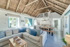 a living room with a couch and a table at Cape Creek Cottage in Struisbaai