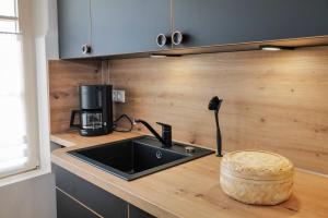 a kitchen with a sink and a coffee maker on a counter at Ferienwohnungen Spiegel - Fewo lue Heaven in Lindau +5 photos