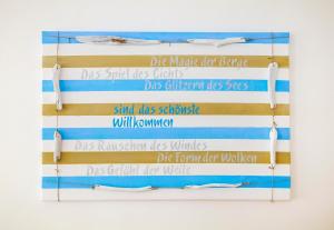 a wall of signs with the names of surfboards at Ferienwohnungen Spiegel - Fewo lue Heaven in Lindau