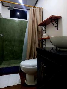 a bathroom with a sink and a toilet and a shower at Genovesa Family home in Puerto Ayora +17 photos