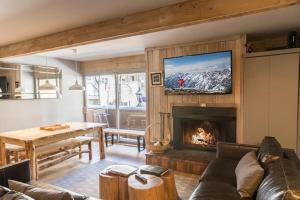 a living room with a couch and a fireplace at Lionshead Arcade with Fireplace & Close to Gondola in Vail
