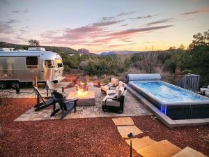 a rv parked next to a swimming pool and a fire pit at Sedona Epic Dream 5BR Pool & Spa Rooftop in Sedona