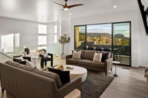 a living room with two couches and a table at Sedona Epic Dream 5BR Pool & Spa Rooftop in Sedona