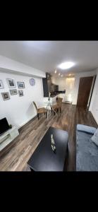 a living room with a couch and a table at Cosy Modern 1-Bed Apartment in Birmingham