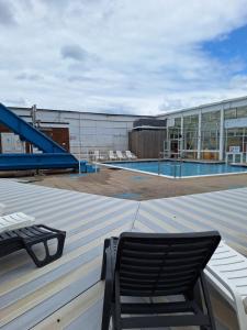 a chair on the roof of a building with a swimming pool at Caravan at the seaside in Great Yarmouth