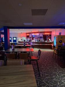 a restaurant with a bar and tables and chairs at Caravan at the seaside in Great Yarmouth