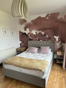a bedroom with a bed with a map on the wall at Basin Road 2 Bed House in Chichester