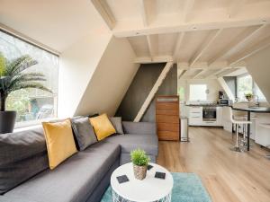 a living room with a couch and a table at Lanaken Lakeside Cabin Stay in Lanaken