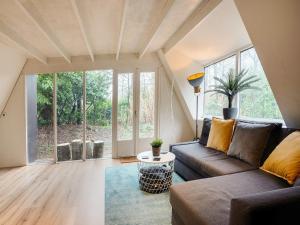 a living room with a couch and a table at Lanaken Lakeside Cabin Stay in Lanaken