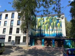 a building with a mural on the side of it at Apartament Motyl in Warsaw