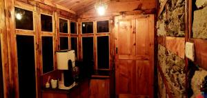 a room with a window in a wooden cabin at Parvatis Lap Luxury Hostel & Camps in Kasol +73 photos
