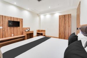 a bedroom with a bed and a flat screen tv at Hotel O Hotel Shiv Lok in Kaliānpur
