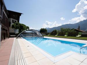 a swimming pool with a metal bridge over it at Alpine Apartment near Kaprun in Piesendorf