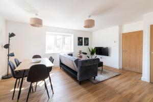 a living room with a couch and a table at Sleek & Cozy 2BR Apartment for Your Stay # 3 in Rothley