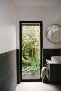 a bathroom with a door leading to a garden at Riverside Retreat in Monaghan +21 photos