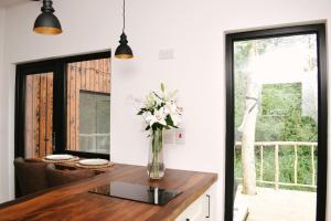 a kitchen with a vase of flowers on a counter at Riverside Retreat in Monaghan