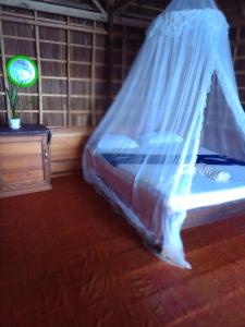 a bedroom with a bed with a mosquito net at "Shady Sea Raja Ampat" in Besir