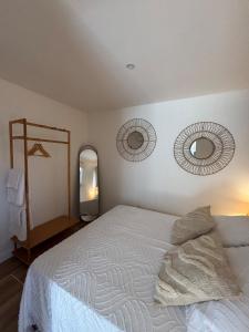 a bedroom with a bed and two mirrors on the wall at Maison in Lamonzie-Saint-Martin +6 photos