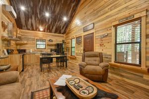 a living room and kitchen in a log cabin at Little Wolf Cabins and ATV Rentals in Mena
