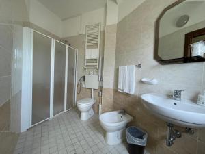 a bathroom with a sink and a toilet and a shower at Hotel Trocadero - Koolibry Hotels in Cervia