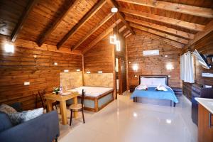 a bedroom with a bed and a table in a room at בקתות ההוד in Kallanit +32 photos