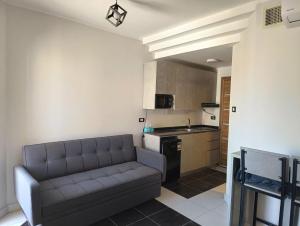 a living room with a couch and a kitchen at Royal Beach Resort in Hurghada