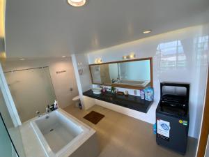 a bathroom with a large tub and a large mirror at Muine, Vietnam, Apartment, 2Br in Phan Thiet