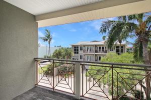 a balcony with a view of a building at Shell Yeah 3 Story Condo On AMI in Holmes Beach